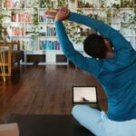 Online Fitness - a man doing yoga in a living room