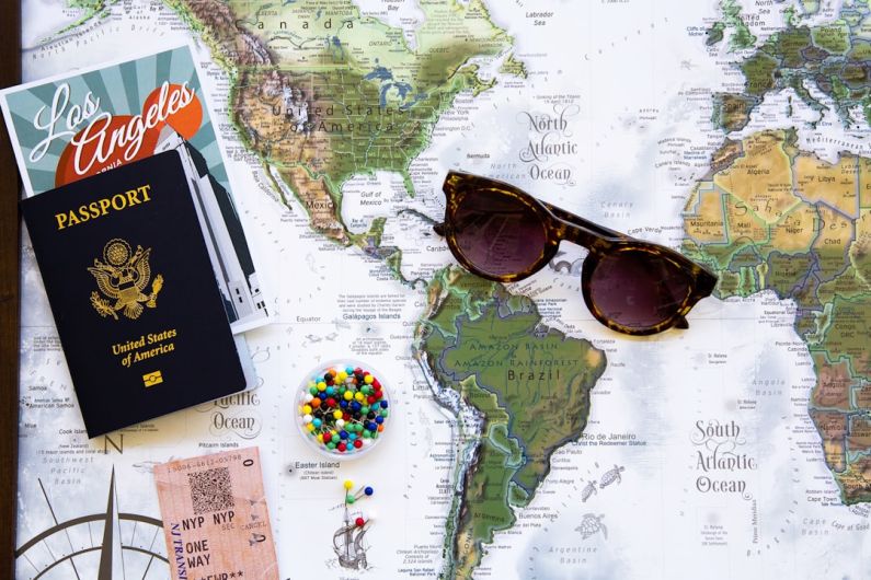 Traveling - brown framed sunglasses on map
