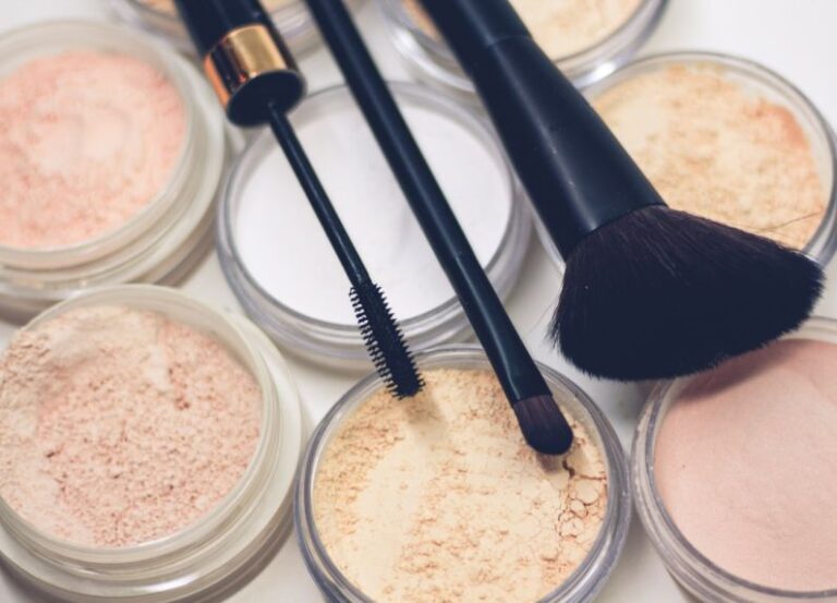 Makeup - three makeup brushes on top of compact powders
