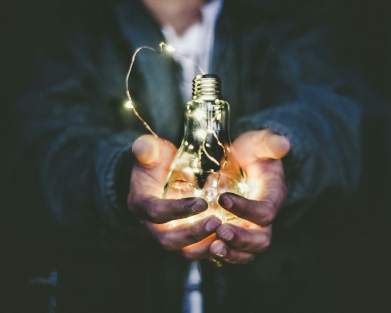 Energy-saving - man holding incandescent bulb