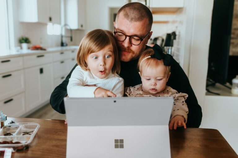 Electronics Home - a man and two children looking at a laptop