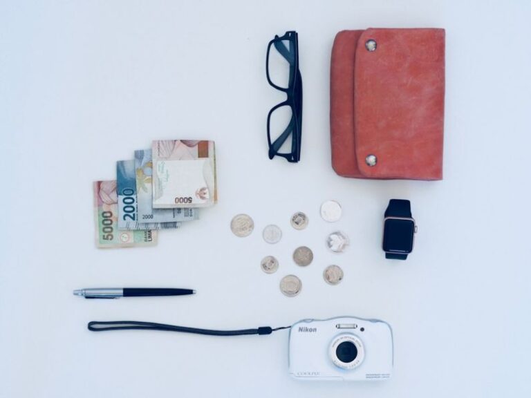 Vacation Money - camera, pen, eyeglasses, watch, coin, and banknote