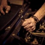 Car Repair - grayscale photo of person playing piano