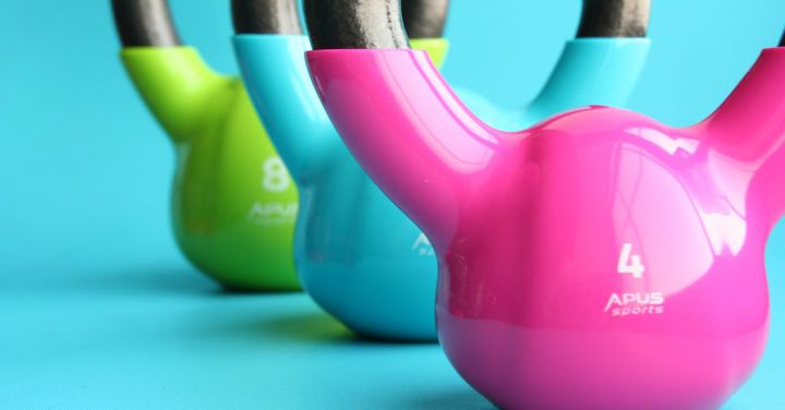 Fitness Equipment - Green, Blue, and Pink Kettle Bells on Blue Surface