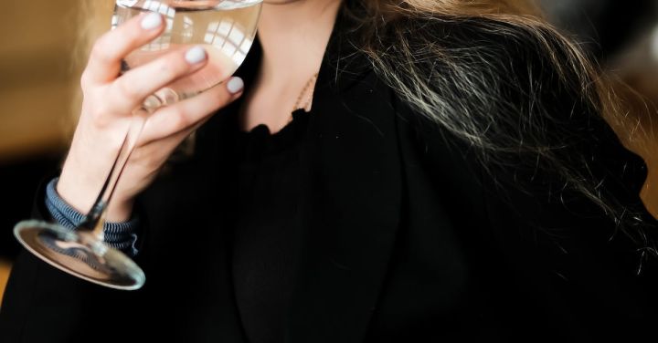 Affordable Wine - Woman in Black Long Sleeve Shirt Holding Clear Wine Glass