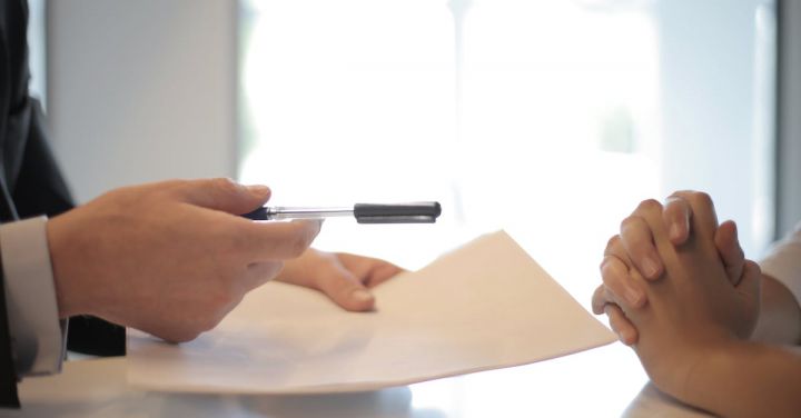 Negotiate - Crop businessman giving contract to woman to sign