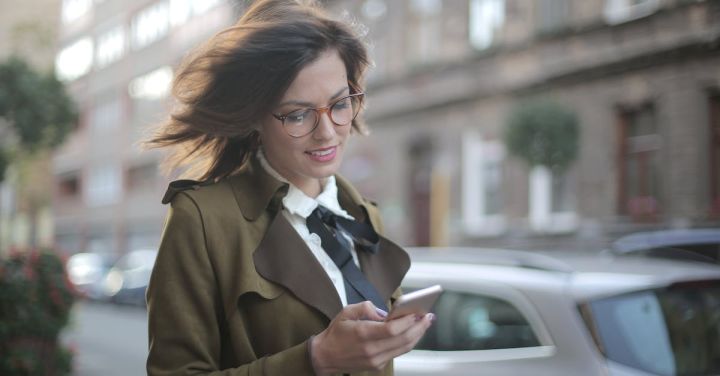 Fashion Apps - Stylish adult female using smartphone on street